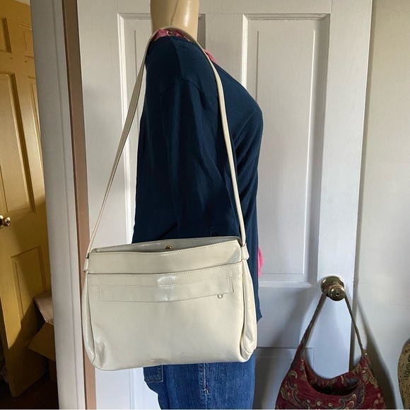 Leather shoulder handbag has 5 compartments that zip or snap for easy access. - Picture 2 of 8